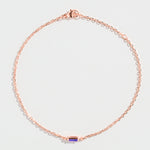 Rose gold bracelet featuring a rectangular blue Tanzanite gemstone at the center.