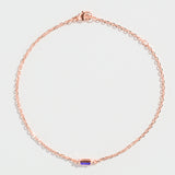 Rose gold bracelet featuring a rectangular blue Tanzanite gemstone at the center.