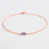 Rose gold bracelet featuring a rectangular blue Tanzanite gemstone at the center.