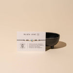 Black bracelet with white description card on beige background reads "protection and prosperity - authoritative and powerful - boosting confidence - potential and possibility" 