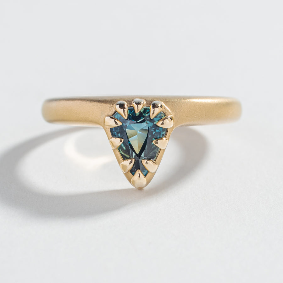 one of a kind engagement ring with blue green teal sapphire pear shape